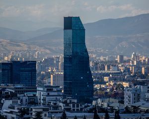 Превью обои небоскреб, здания, горы, город