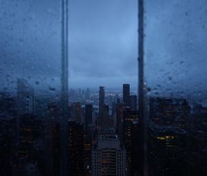 Превью обои ночной город, окно, дождь, небоскребы, вид сверху