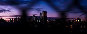 Превью обои ночной город, забор, темный, небоскребы