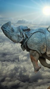Превью обои носорог, крылья, полёт, облака, икар