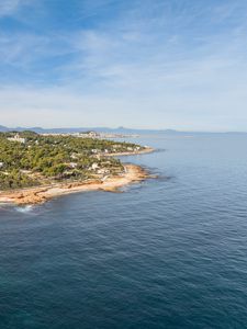 Превью обои остров, море, деревья, здания, небо, природа