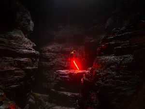 Превью обои пещера, человек, лазерный меч, свет