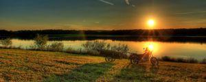 Превью обои река, мотоцикл, закат, трава