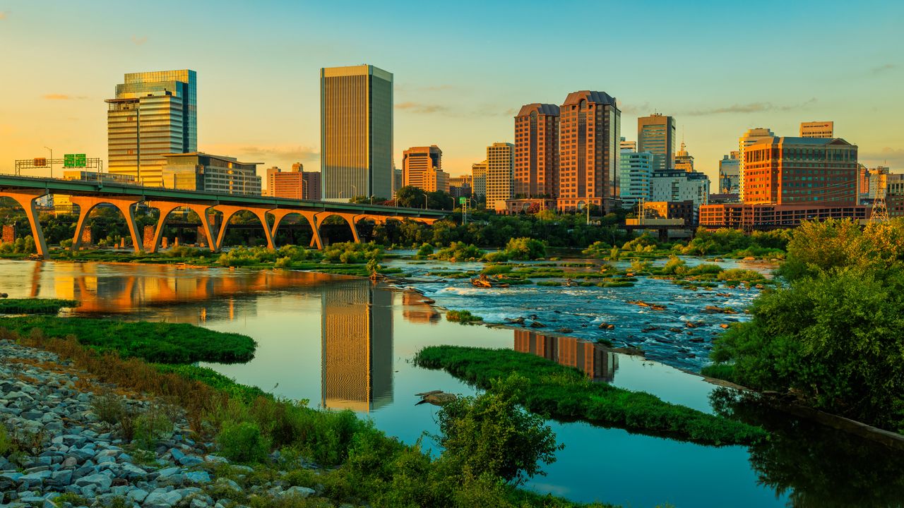 Обои река, зелень, мост, здания, город, закат