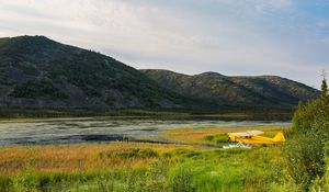 Превью обои самолет, желтый, поле, холмы, пейзаж