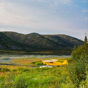 Превью обои самолет, желтый, поле, холмы, пейзаж