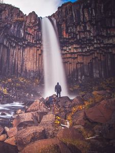 Превью обои скала, гора, водопад, человек, силуэт, камни