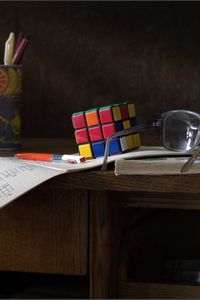Превью обои стол, очки, инструкция, кубик рубик, ручки, линейка, книги