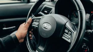 Превью обои subaru, автомобиль, руль, руки, черный