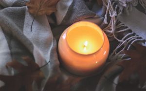 Превью обои свеча, листья, осень, ткань, пламя