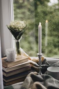 Превью обои свеча, окно, букет, дождь, книги, плед, чашка
