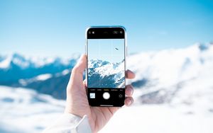 Превью обои телефон, рука, снимок, горы, снег, зима