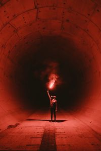 Превью обои тоннель, человек, противогаз, свет, огонь, красный