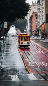 Превью обои трамвай, рельсы, улица, дождь, здания