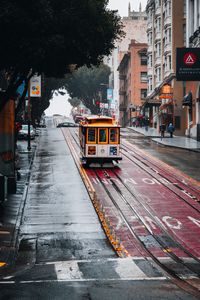 Превью обои трамвай, рельсы, улица, дождь, здания