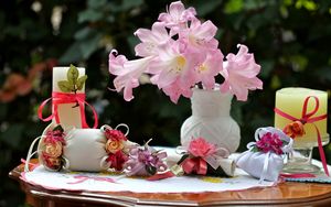 Превью обои цветы, ваза, розы, мешочки, банты, свечи, стол