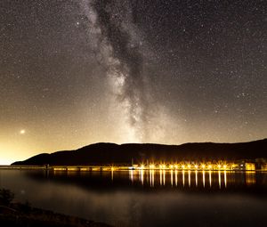 Превью обои туманность, звездное небо, звезды, пристань, огни, ночь