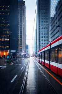 Превью обои улица, город, трамвай, здания, дождь