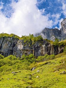 Превью обои утес, скала, трава, облака