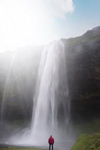 Превью обои водопад, обрыв, солнечный свет, брызги, человек